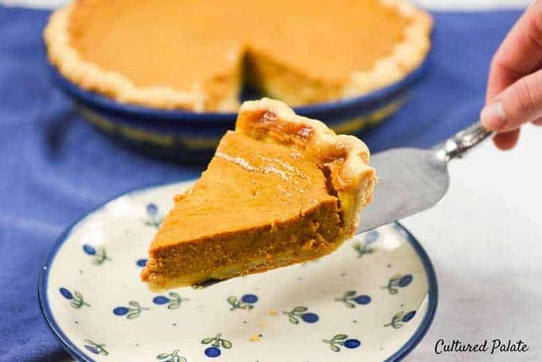 A slice of Easy Pumpkin Pie on a white and blue plate