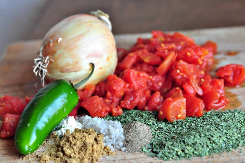 ingredients for making an easy homemade salsa recipe on a chopping board