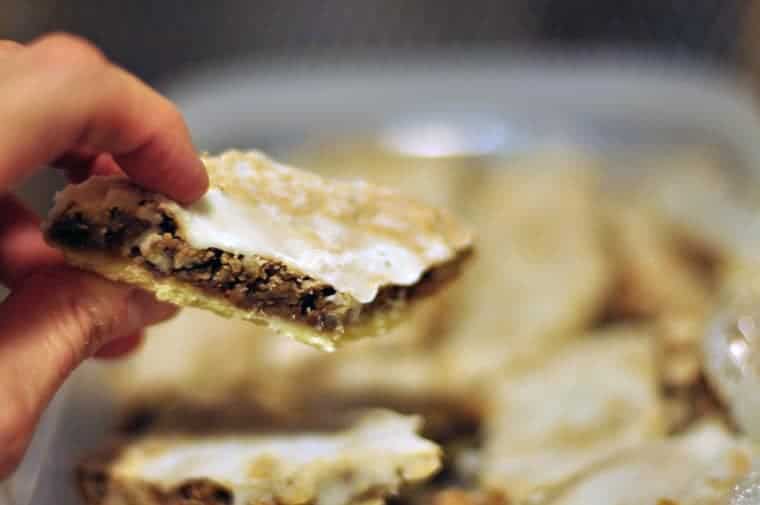 A hand holding angle wings cookies