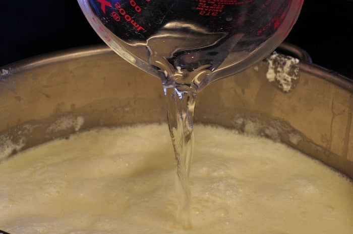 adding diluted rennet to milk for homemade mozzarella cheese