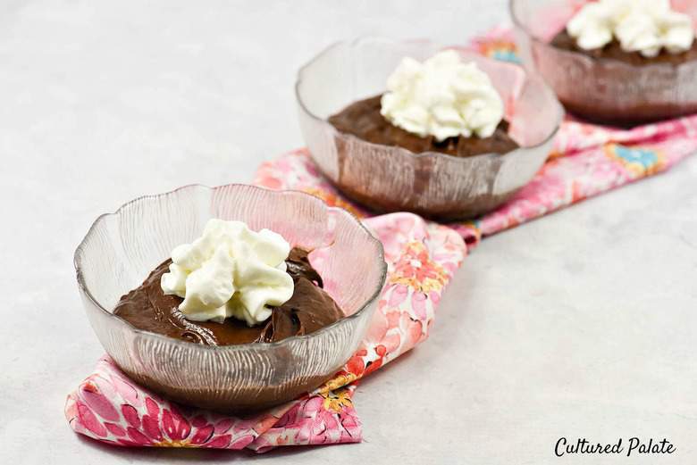 Chocolate Avocado Pudding  - 3 bowls filled with pudding and topped with whipped cream