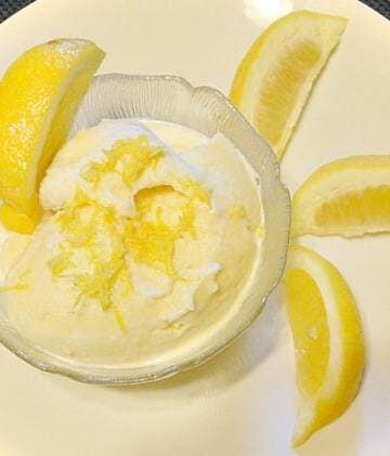 Lemon Frozen Yogurt shown in bowl with lemon wedges around it