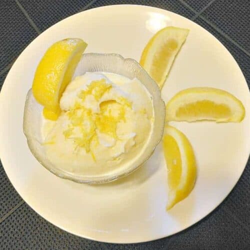 Lemon Frozen Yogurt shown in bowl with lemon wedges around it