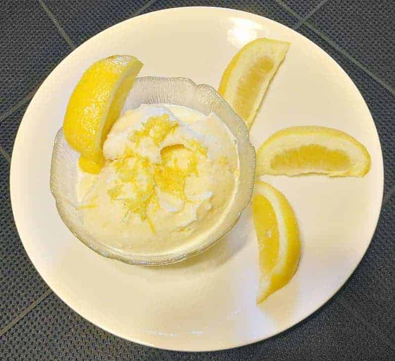 Lemon Frozen Yogurt shown in bowl with lemon wedges around it