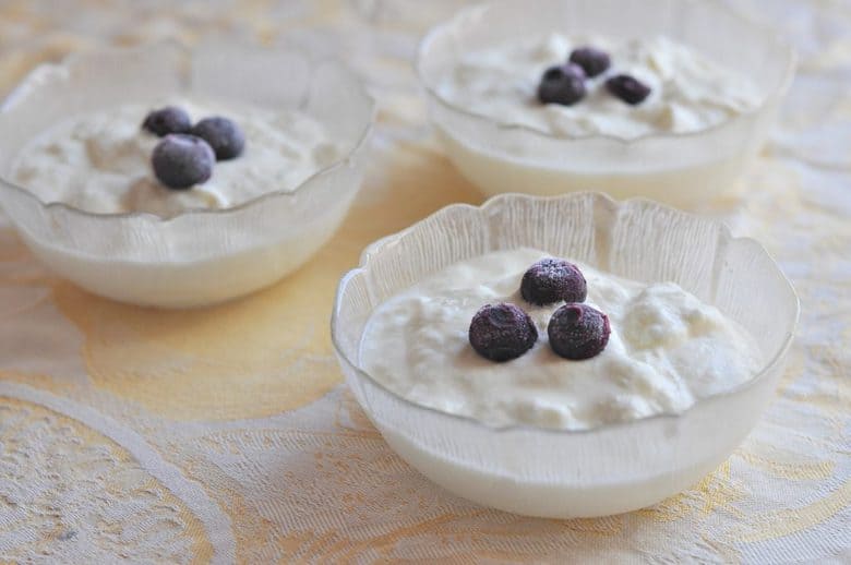 homemade yogurt in three glass bowls topped with blueberries from How to Make Yogurt at home post