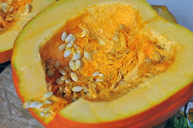 A photo of the inside of a squash with seeds