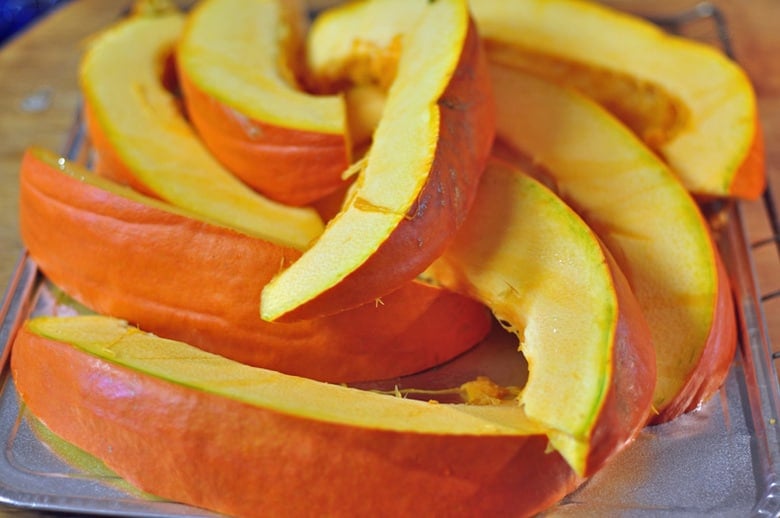 Squash cut into wedges ready to be baked in the oven