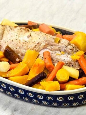 Oven Roasted Pork Loin with veggies in a polish pottery dish.