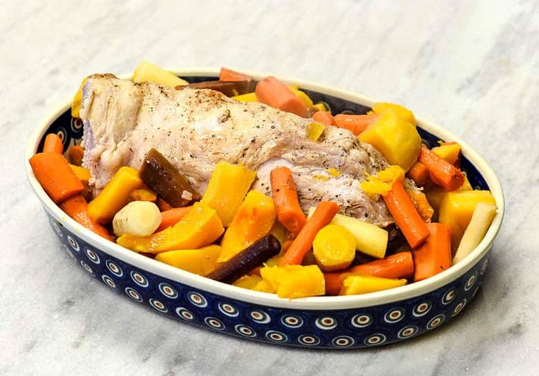 Oven Roasted Pork Loin with veggies in a polish pottery dish.