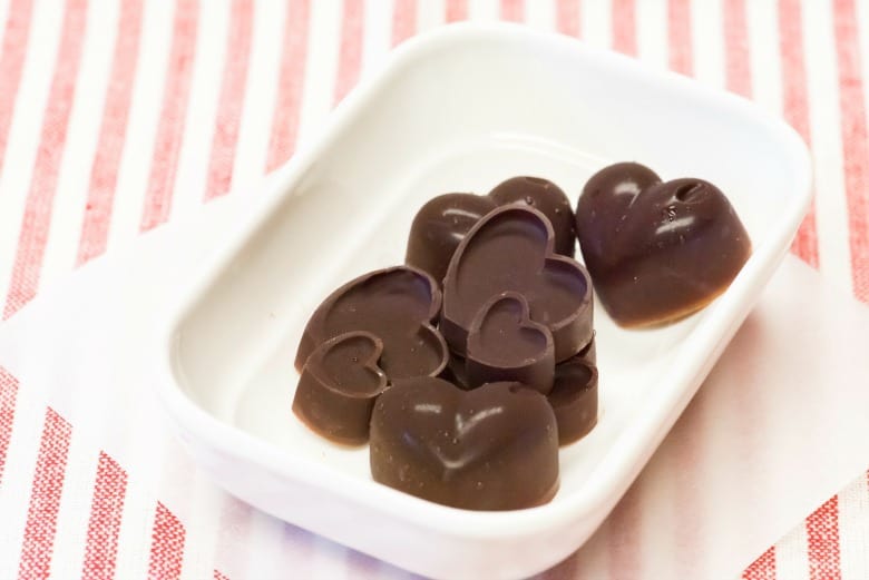 Chocolate Coconut Candy shown in white bowl on striped napkin.