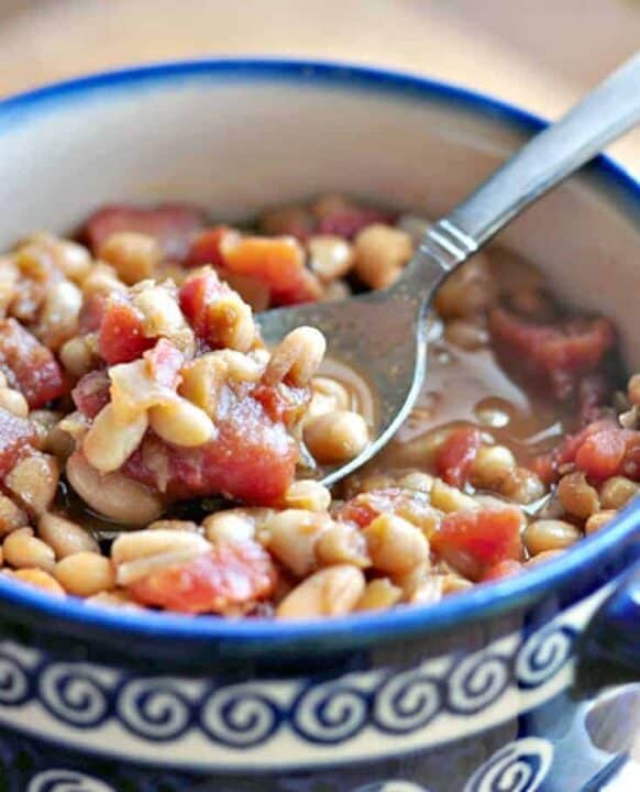 Close up of Homemade Baked Bean Recipe shown in bowl with spoon ready to eat