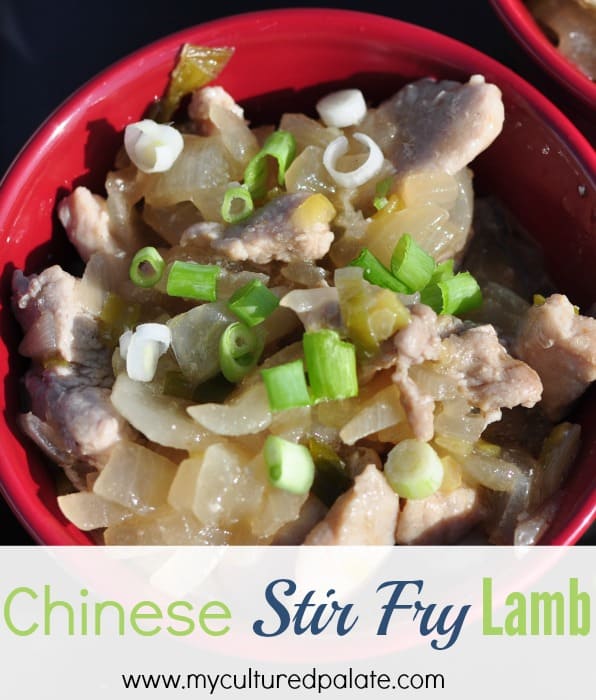 A close up of Chinese lamb stir fry in a red bowl