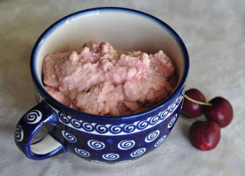 Black Cherry Frozen Yogurt recipe shown with cherries in a blue mug