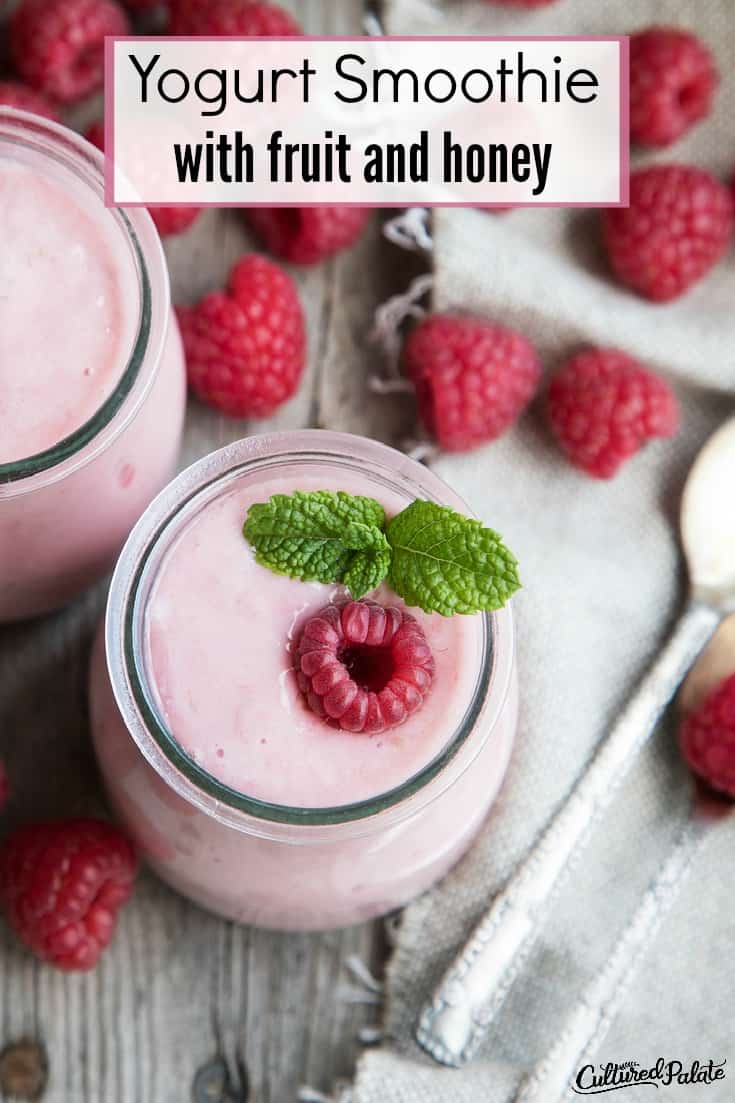 Yogurt Smoothie from overhead with raspberry on top and around with text overlay.