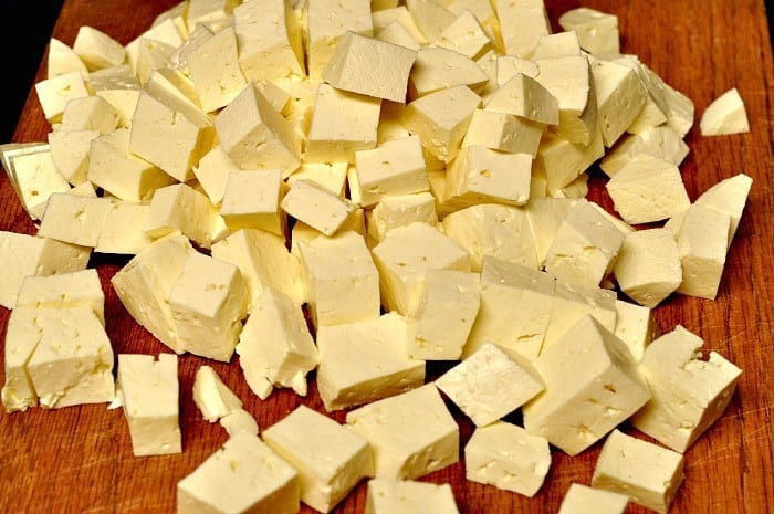 Cubes of feta cheese cut up on a board. A recipe for how to make feta cheese