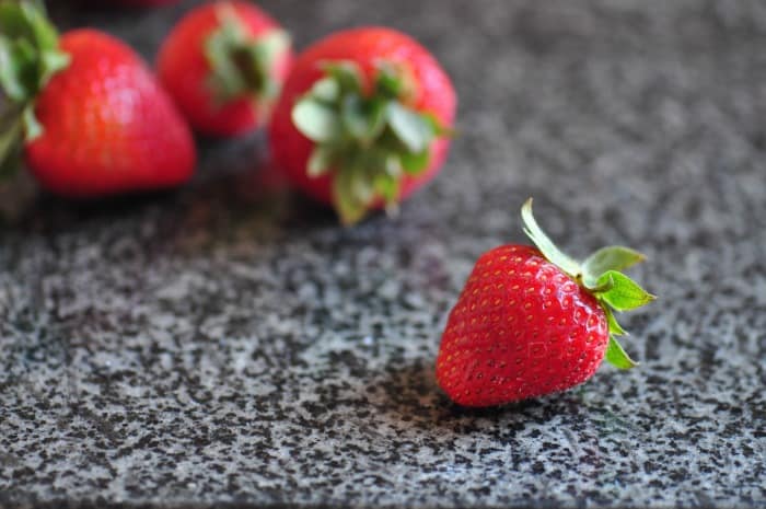 A close up of strawberries uses to top homemade cottage cheese