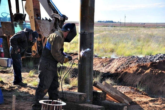 welding the well casing pipes togther as they go into the ground