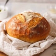 Basic Sourdough Bread shown on tea bowl and cutting board.