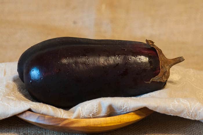 A photo of an eggplant on a table to make eggplant lasagna