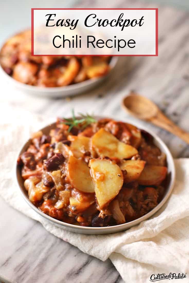 Crockpot Chili Recipe shown in white bowl with wooden spoon on side with text overlay.