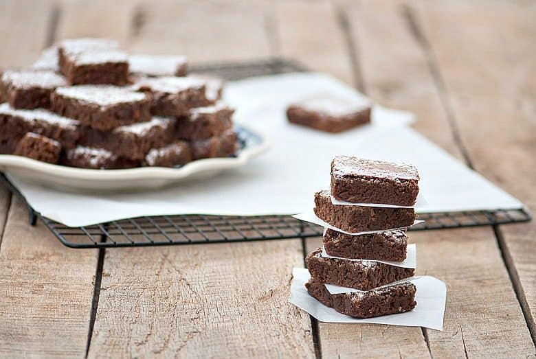 The Best Brownies made from the Easy Brownie Recipe shown stacked on wooden table