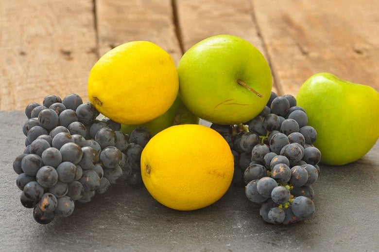 grapes, lemons and apples on a surface ready to make red wine sangria