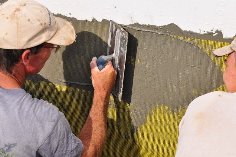 Pressing the cement into the fiberglass mesh of EIFS