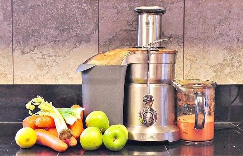 Carrot Juice Recipe ready to be made. Breville Juicer and produce shown on counter