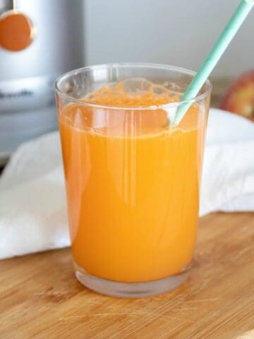 Easiest carrot juice recipe shown ready to drink in glass.