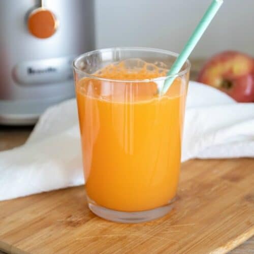 Easiest carrot juice recipe shown ready to drink in glass.