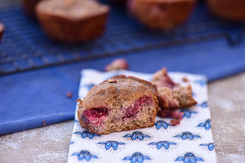 A close up shot of Gluten-Free Strawberry Muffins with a bite out
