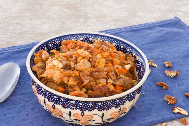 A close up side shot of a large bowl filled with Sweet Potato Stuffing