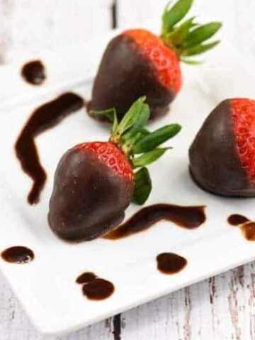 Three Chocolate Covered Strawberries with Coconut Oil Chocolate on a white plate