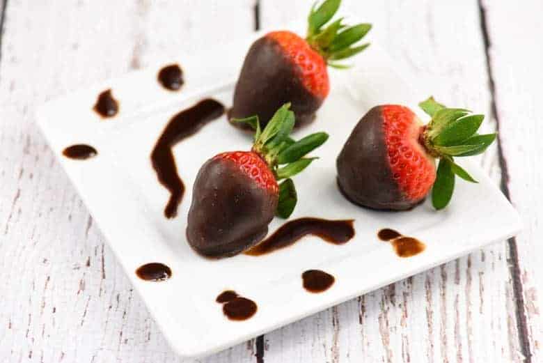 A close up of three Chocolate Covered Strawberries with Coconut Oil Chocolate