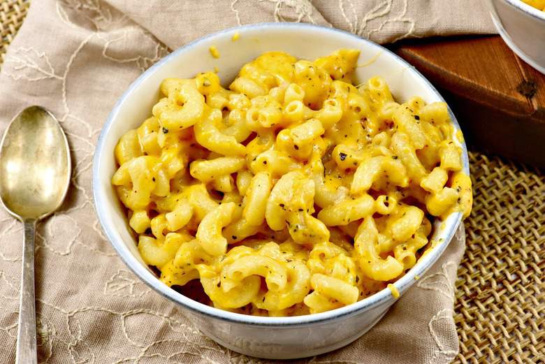 A close up of a bowl of Mac and cheese made from the Creamy Macaroni and Cheese recip with a spoon