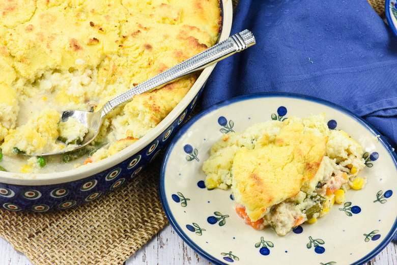 A photo of Gluten Free Chicken Pot Pie in a baking dish with some on a plate