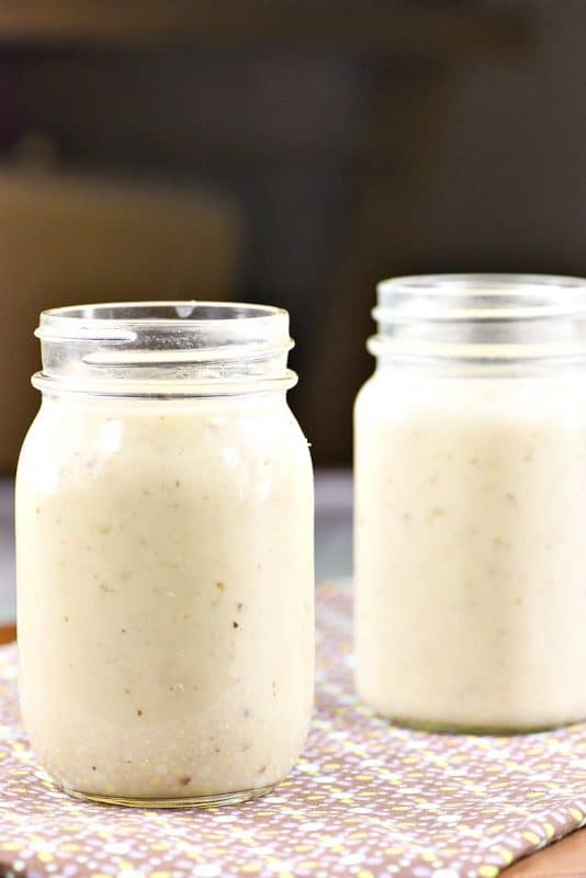 Homemade Cream of Chicken Soup Recipe shown on dark background in jars