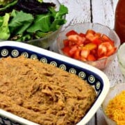 Homemade Refried Beans in a large baking dish on a table