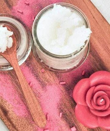 sugar scrub on wooden tray with a candle
