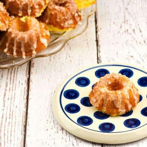 A photo of Lemon Supreme Tea Cakes on a blue and white plate