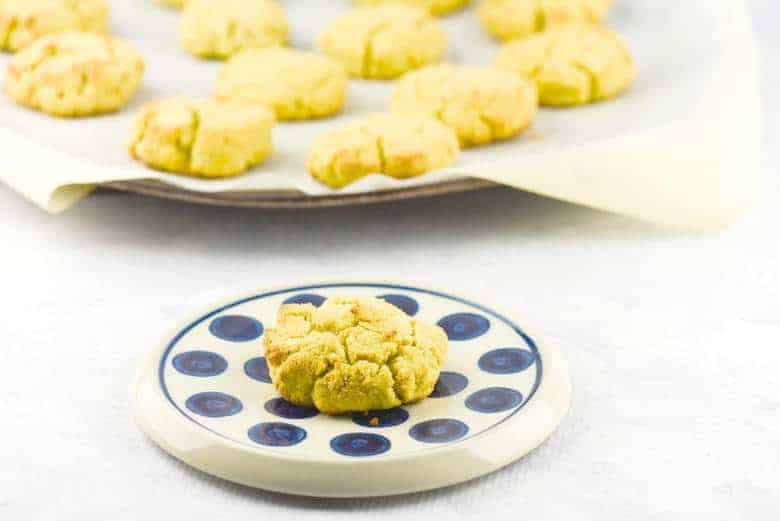 A photo of Coconut Flour Biscuits in the background and one up close on a blue and white plate