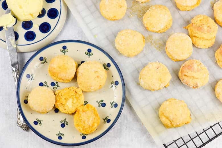 An overhead shot of Sweet Potato Biscuits on a blue plate and some on a tray