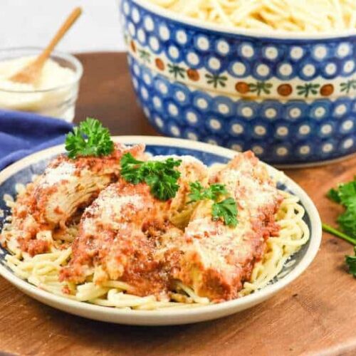 A close up of Crock Pot Chicken Parmesan with spaghetti