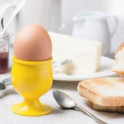 A boiled egg in a cup with toast