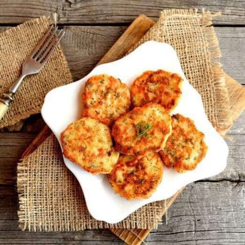 Baked Salmon Croquettes on a white plate sitting on a wooden table