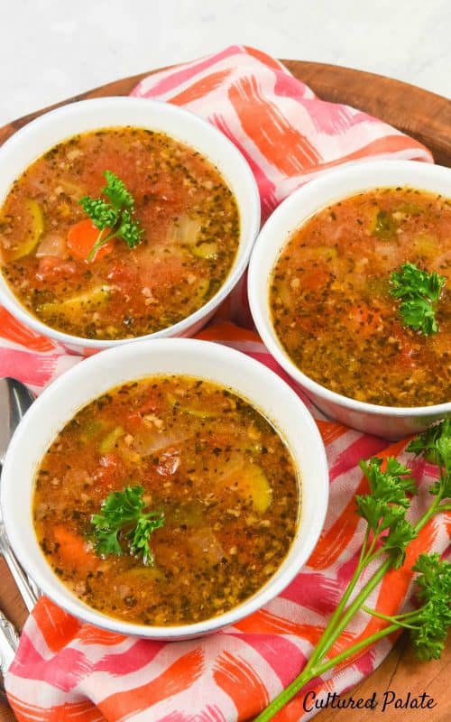 A close up of Instant Pot Minestrone Soup in three bowls garnished with parsley