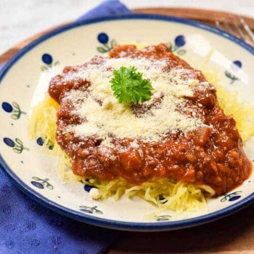 Instant Pot Spaghetti squash shown cooked with tomato sauce on top, ready to eat.