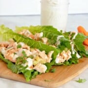 Buffalo Chicken Lettuce Wraps shown on a cutting board with homemade ranch in the background