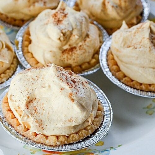 Mini Pumpkin Pies shown on a white floral plate close up