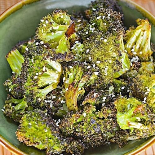 Sesame Oven Roasted Broccoli shown in a green bowl with sesame seeds on top